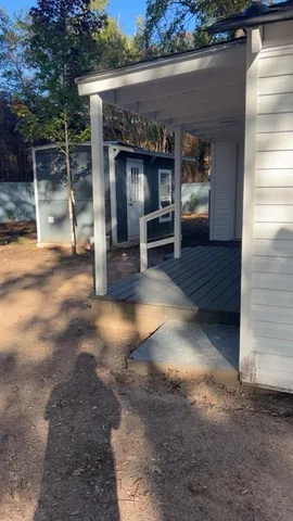 a view of a livingroom with furniture and floor to ceiling window
