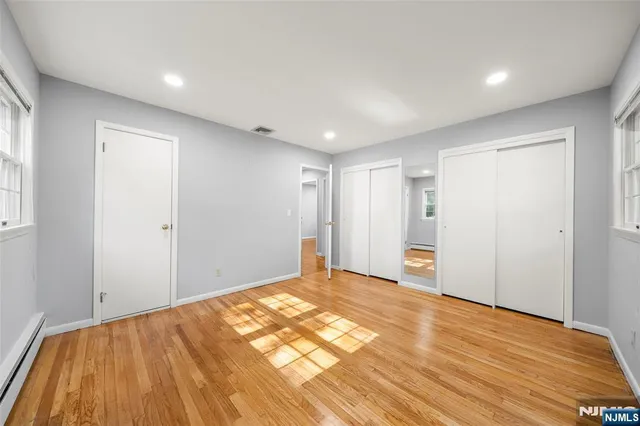 a view of an empty room and wooden floor