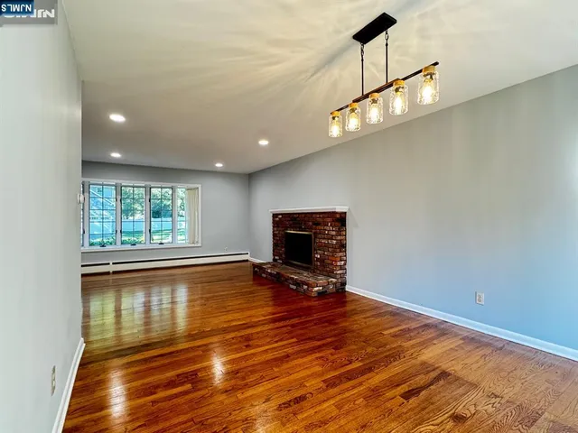 a view of livingroom with furniture wooden floor and windows