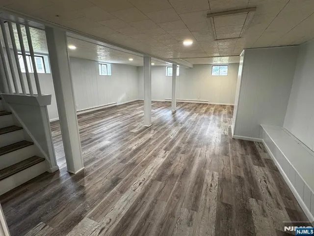 a view of hallway with stairs and wooden floor