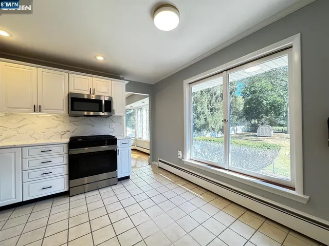 a kitchen with stainless steel appliances a stove sink and microwave