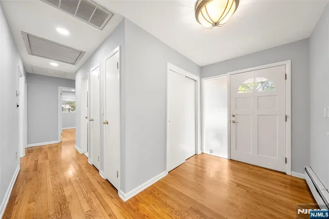 a view of a room with wooden floor