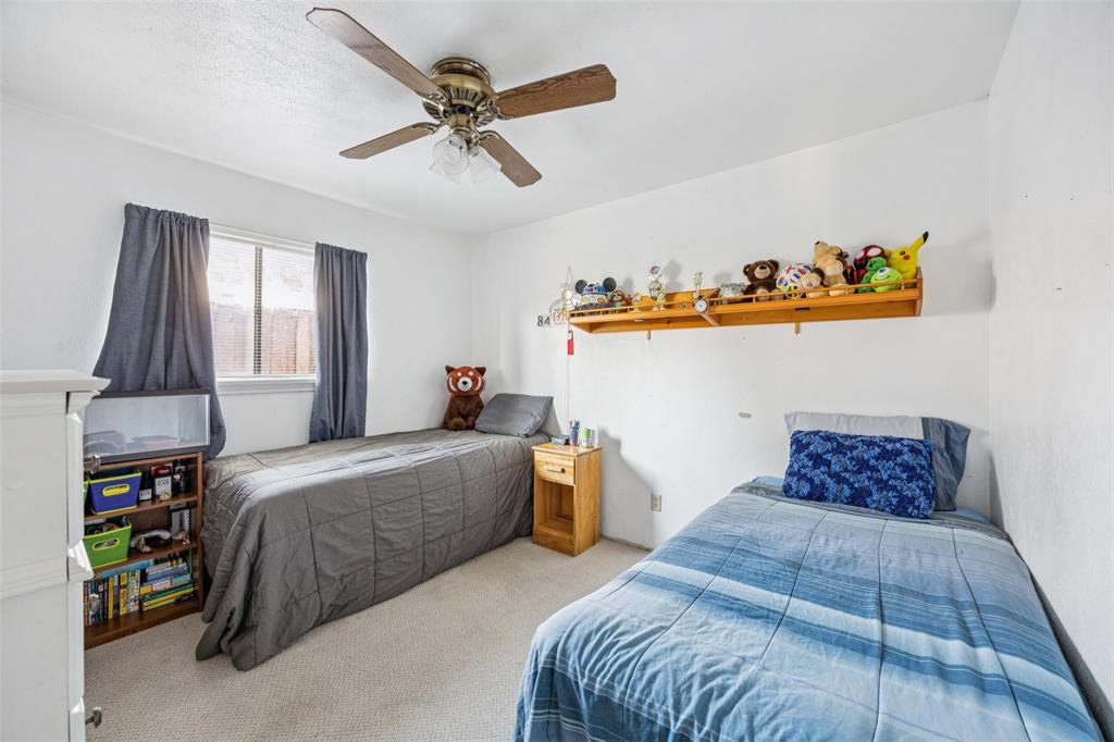 3113 Ridgemoor Drive Garland, TX 75044 - Photo 11 of 30 a bedroom with a bed and dresser