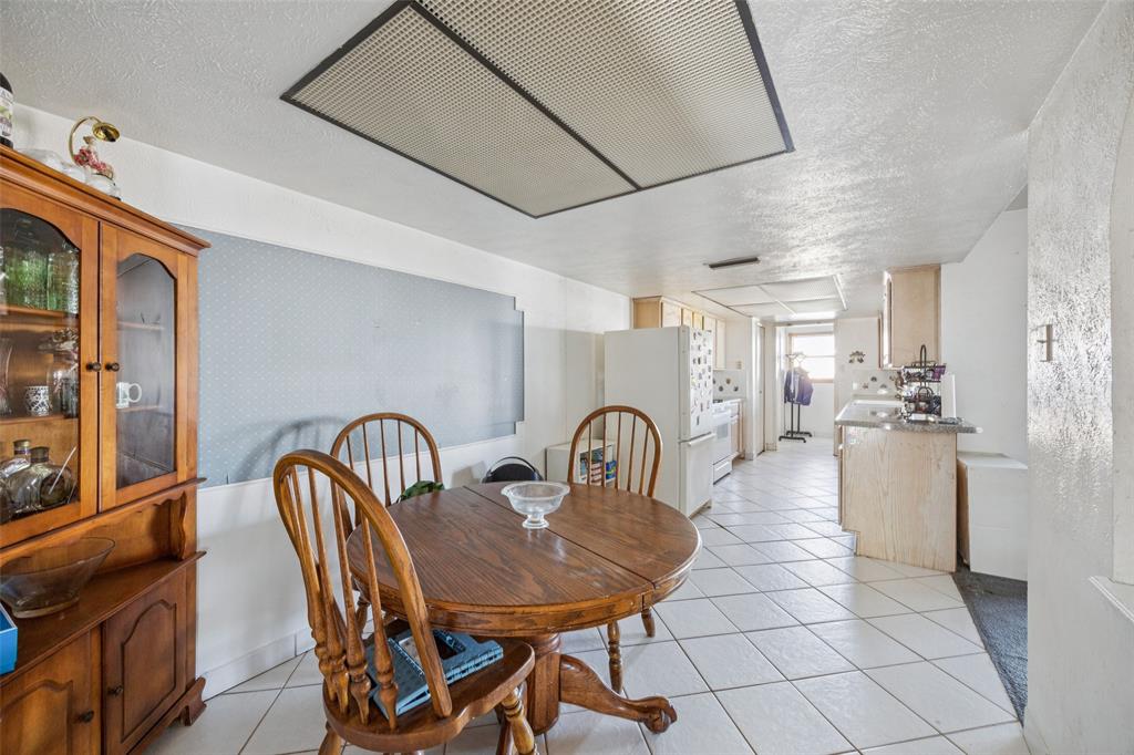 3113 Ridgemoor Drive Garland, TX 75044 - Photo 17 of 30 a dining room with furniture and a chandelier