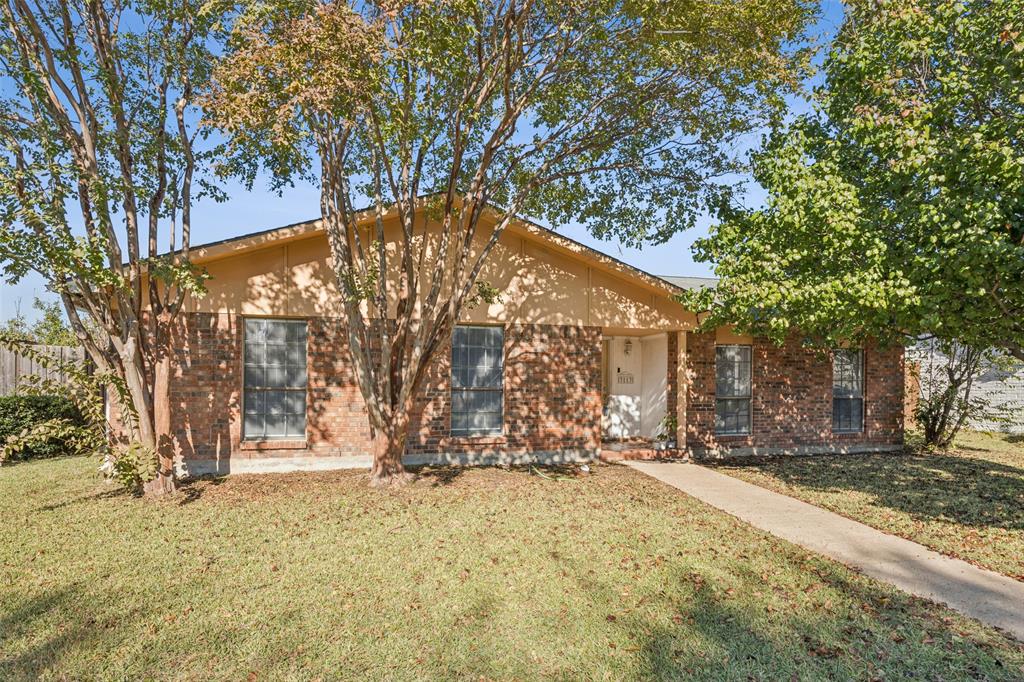 3113 Ridgemoor Drive Garland, TX 75044 - Photo 2 of 30 a view of wooden fence under a large tree