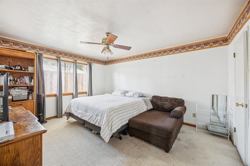 3113 Ridgemoor Drive Garland, TX 75044 - Photo 26 of 30 a bedroom with a bed couch and a window