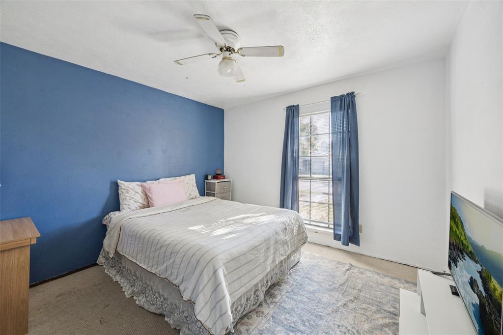 3113 Ridgemoor Drive Garland, TX 75044 - Photo 9 of 30 a bedroom with a bed and a flat screen tv