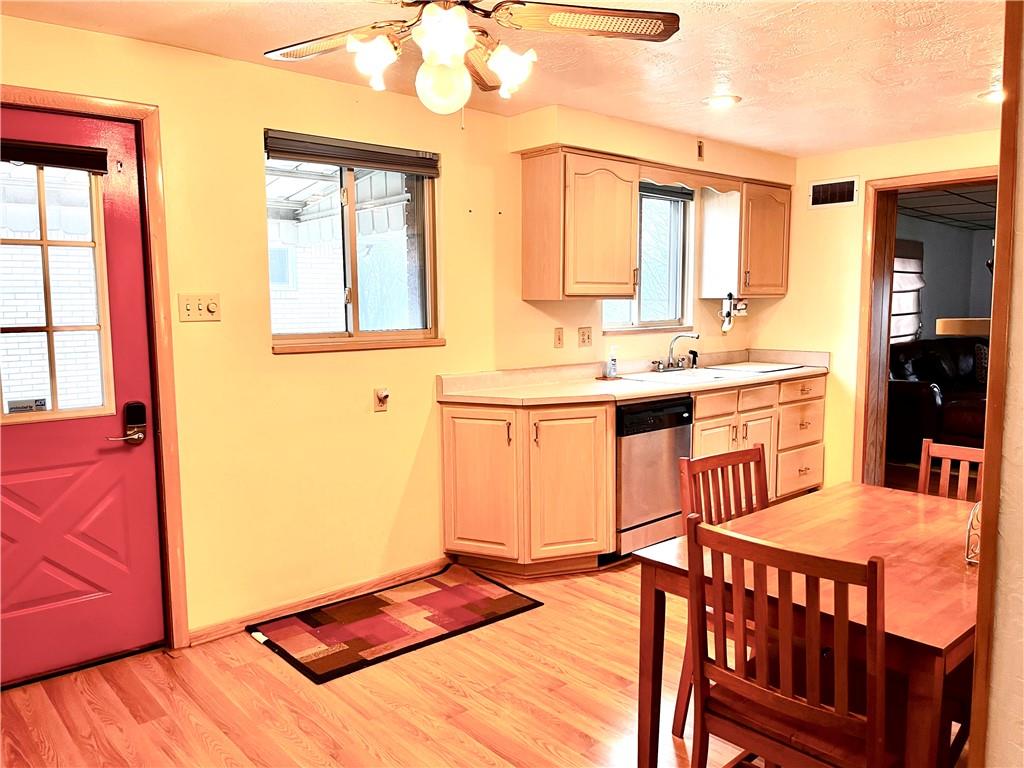 3531 Bevan Road North Versailles, PA 15137 - Photo 7 of 23 Kitchen cabinets with sink looking out to the yard.