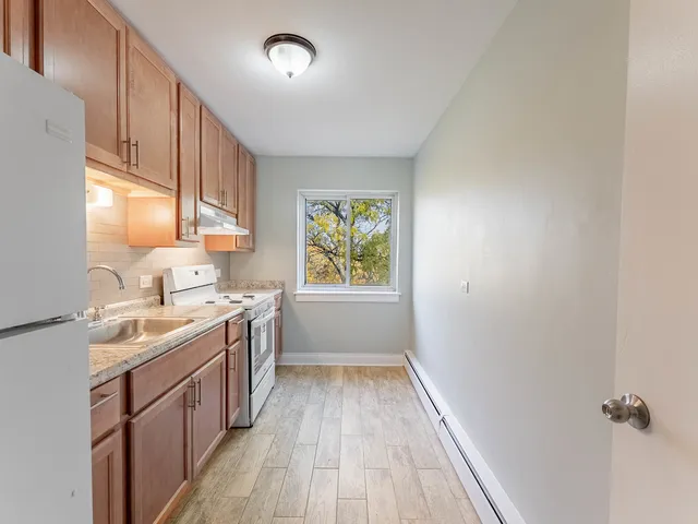 a kitchen with a sink stove and cabinets