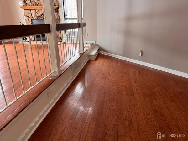 a view of a room with wooden floor