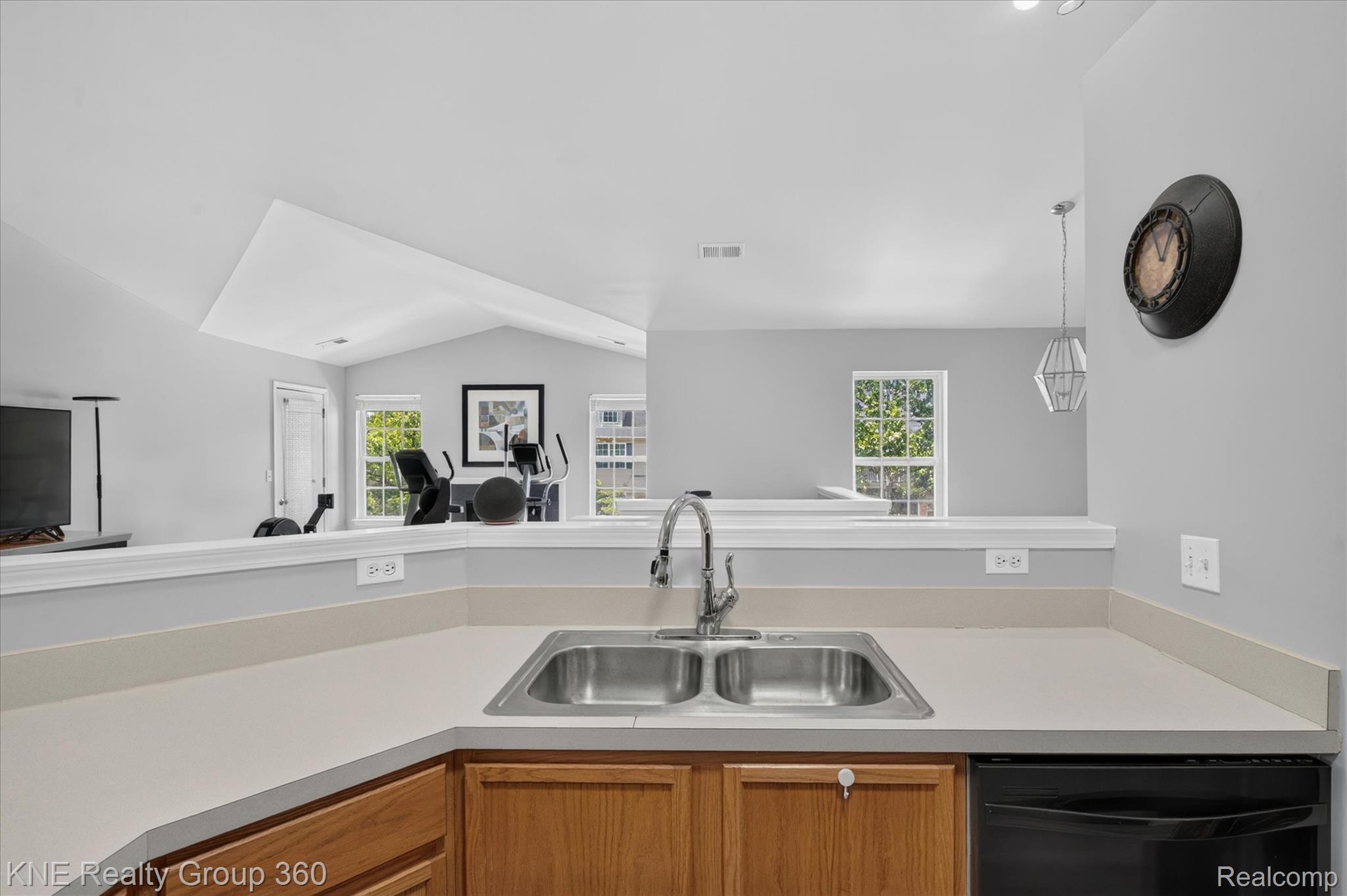4077 Berkeley Avenue Canton, MI 48188 - Photo 13 of 32 Kitchen area featuring a stainless steel double basin sink, neutral countertops, and wood-finish cabinetry