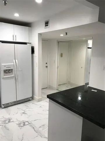 a kitchen with a refrigerator and a stove
