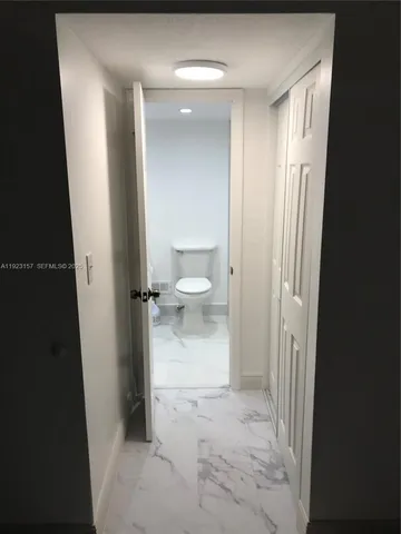 a view of a bathroom from a hallway