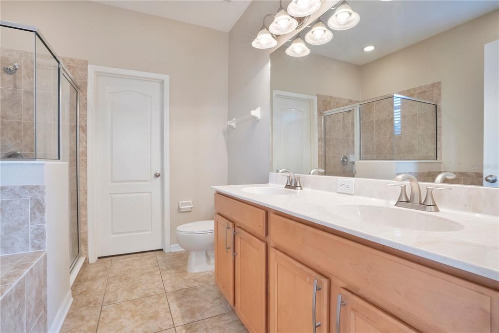 15031 Skip Jack Loop Lakewood Ranch, FL 34202 - Photo 15 of 27 a bathroom with a double vanity sink and a mirror