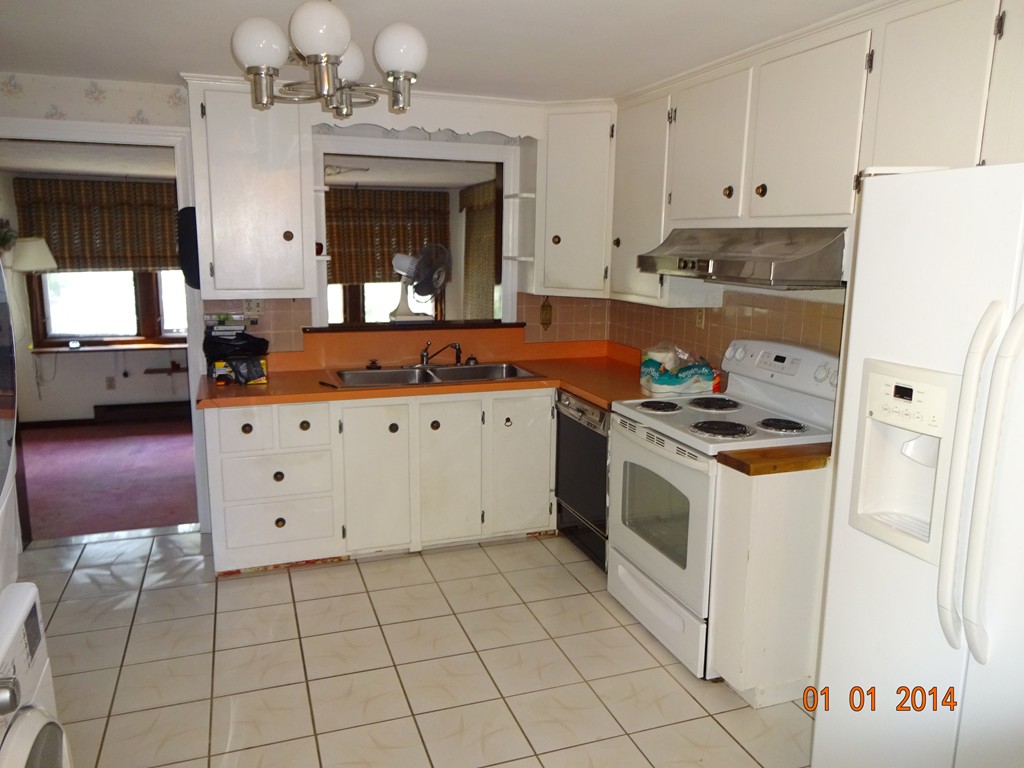 3 Sherwood Road Worcester, MA 01602 - Photo 5 of 12 a kitchen with a stove a sink and a refrigerator
