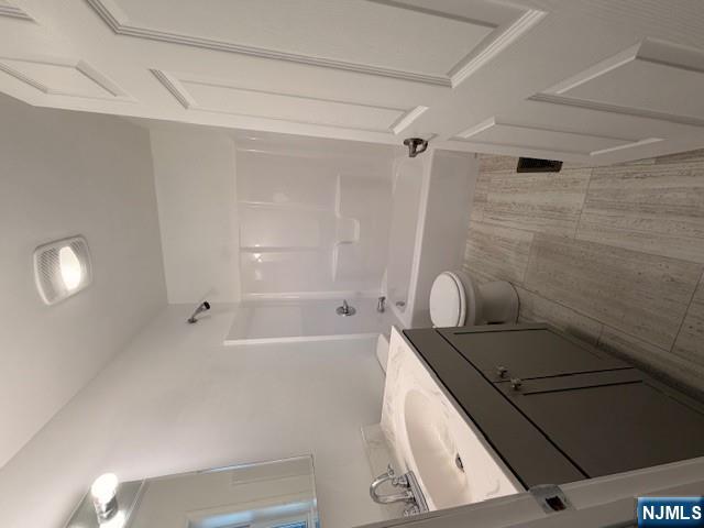 65 Barbour Street, Unit 1 Haledon, NJ 07508 - Photo 13 of 18 a bathroom with a sink a toilet and shower