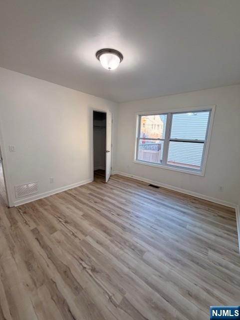 65 Barbour Street, Unit 1 Haledon, NJ 07508 - Photo 16 of 18 an empty room with wooden floor and windows