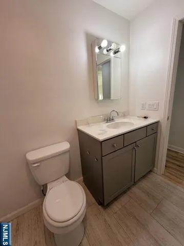 a bathroom with a toilet a sink and mirror