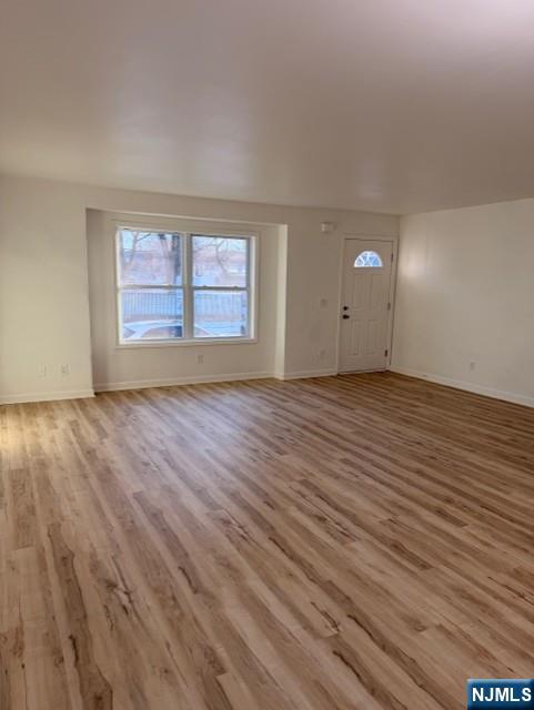 65 Barbour Street, Unit 1 Haledon, NJ 07508 - Photo 2 of 18 wooden floor in an empty room with a window