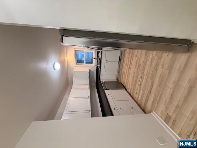 65 Barbour Street, Unit 1 Haledon, NJ 07508 - Photo 5 of 18 a large white kitchen with granite countertop a refrigerator