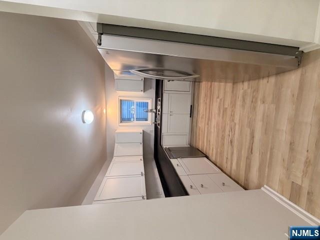 65 Barbour Street, Unit 1 Haledon, NJ 07508 - Photo 6 of 18 a large kitchen with cabinets stainless steel appliances a sink and a window