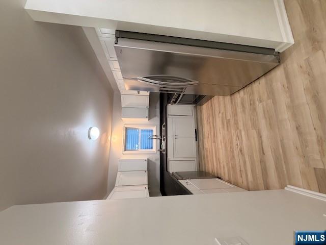 65 Barbour Street, Unit 1 Haledon, NJ 07508 - Photo 7 of 18 a large kitchen with a refrigerator a stove top oven a sink and dishwasher