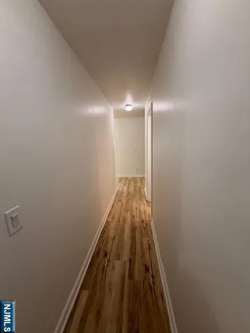 a view of hallway with wooden floor
