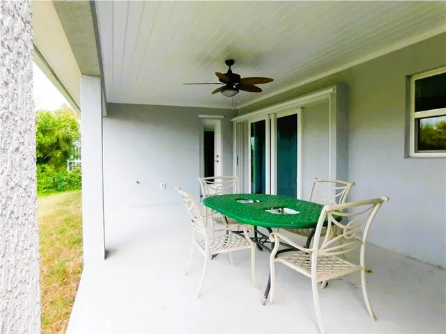 a view of a dining room with furniture and a window