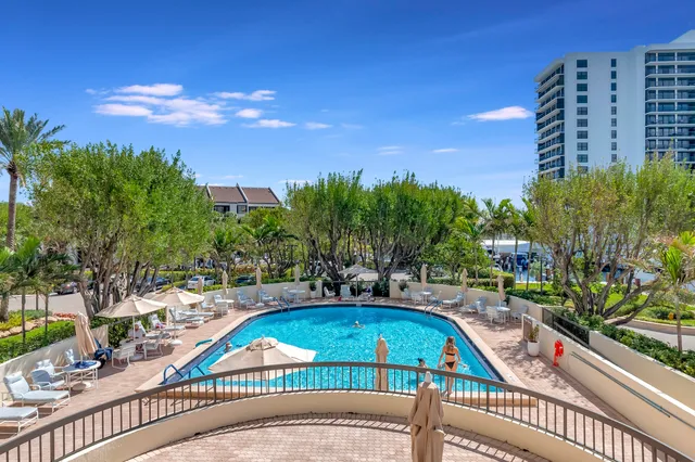 an aerial view of a house with a swimming pool and outdoor seating
