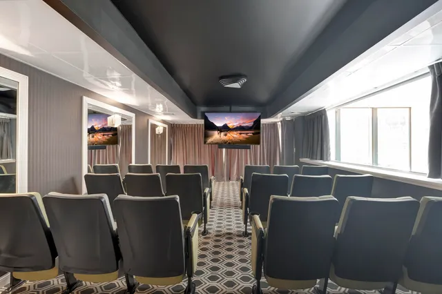 a living room with furniture large window and flat screen tv