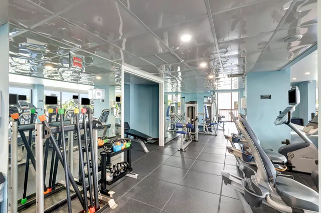 an aerial view of ocean and residential houses with outdoor space