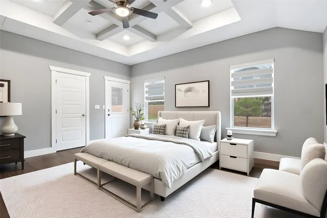 an empty room with wooden floor chandelier fan and windows
