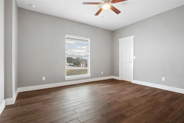 wooden floor in an empty room with a window