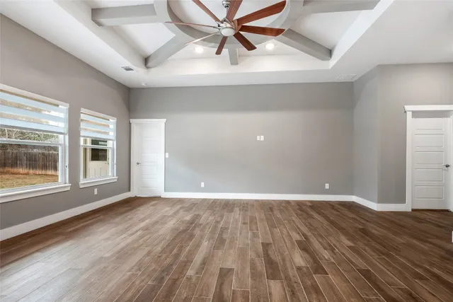 wooden floor in an empty room with a window