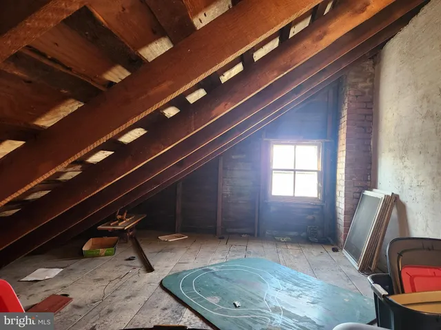 a view of a kitchen with a sink and wooden floor