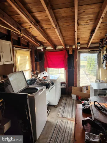 a room with water heater and utility racks