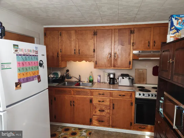 a kitchen with stainless steel appliances a stove a microwave and a refrigerator