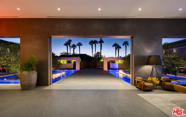 a bedroom with furniture and a chandelier