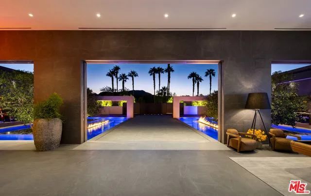a bedroom with furniture and a chandelier