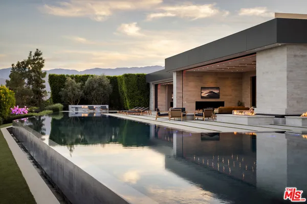 a view of swimming pool with outdoor seating and plants