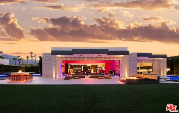 a room with pool table and windows