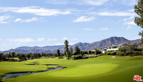 a view of a lush green hillside and a houses