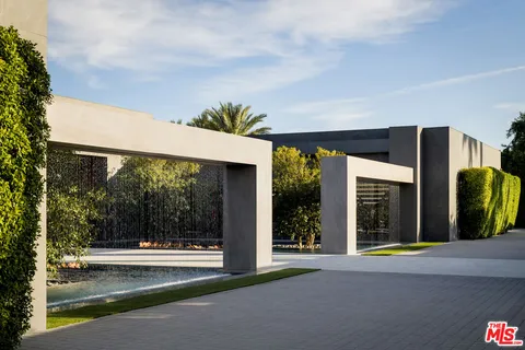 a view of a house with a porch and floor to ceiling window