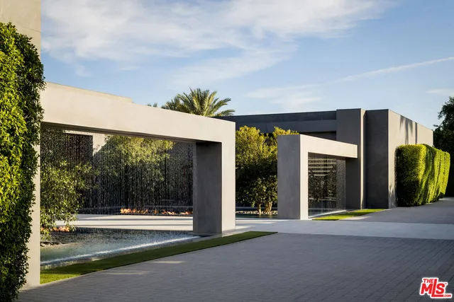 a view of a house with a porch and floor to ceiling window