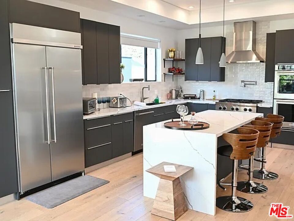1410 Coronado Terrace Los Angeles, CA 90026 - Photo 1 of 27 a kitchen with stainless steel appliances a sink a stove a refrigerator and island