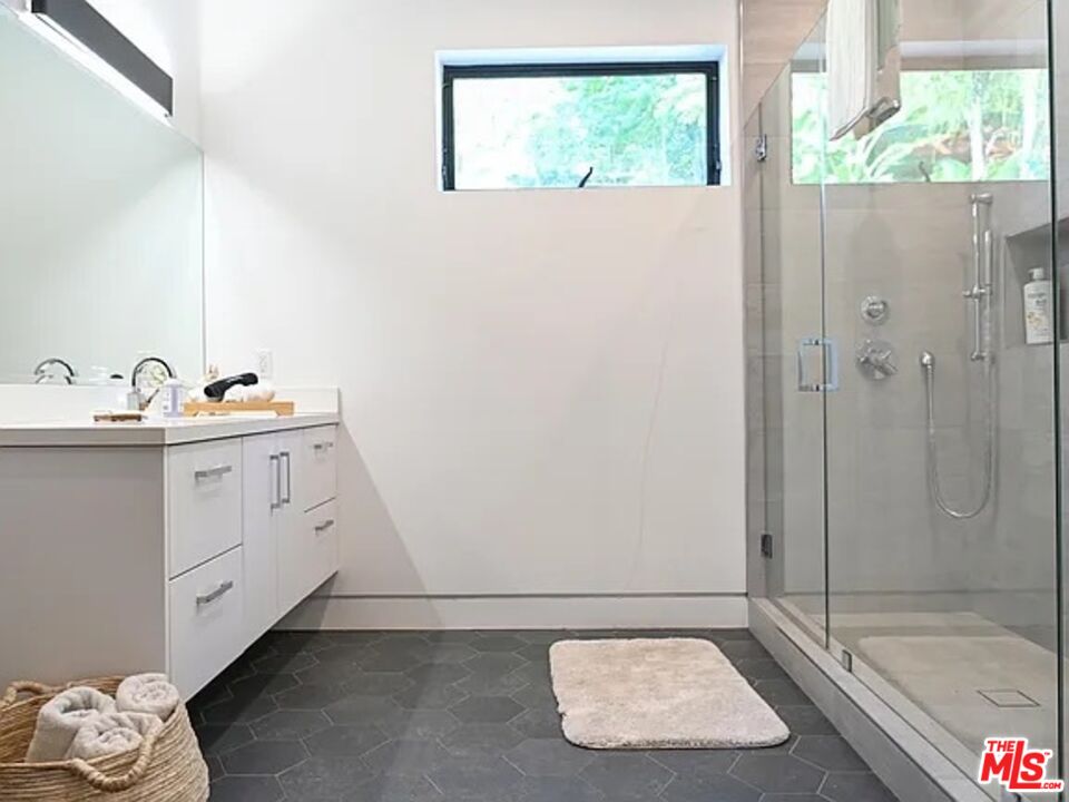 1410 Coronado Terrace Los Angeles, CA 90026 - Photo 17 of 27 a bathroom with a sink and a mirror with bathtub