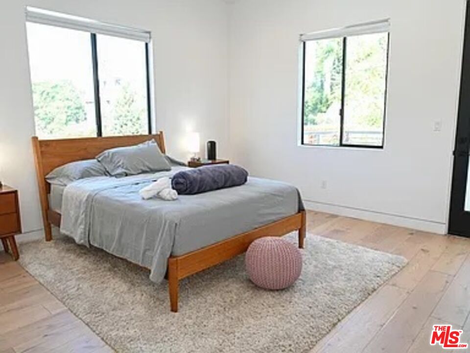 1410 Coronado Terrace Los Angeles, CA 90026 - Photo 18 of 27 a bedroom with a bed and window
