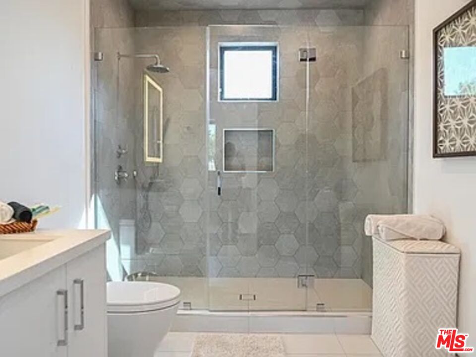 1410 Coronado Terrace Los Angeles, CA 90026 - Photo 19 of 27 a bathroom with a bathtub shower sink vanity and toilet