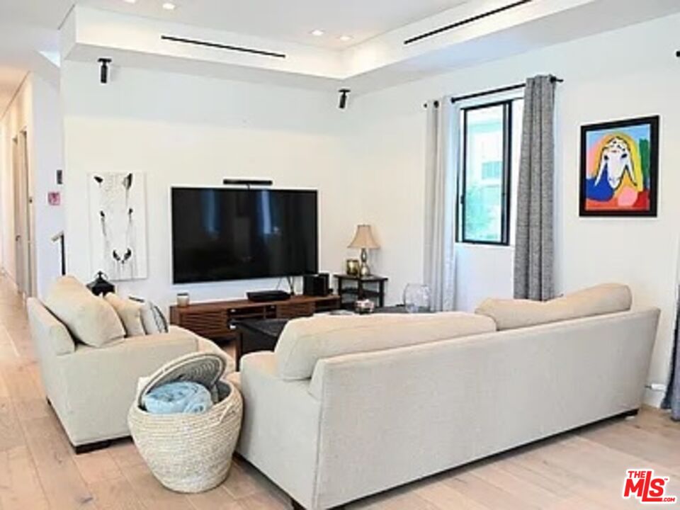 1410 Coronado Terrace Los Angeles, CA 90026 - Photo 3 of 27 a living room with furniture and a flat screen tv