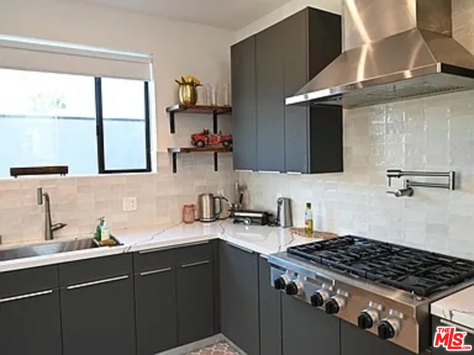 1410 Coronado Terrace Los Angeles, CA 90026 - Photo 4 of 27 a kitchen with stainless steel appliances a sink dishwasher a stove and a refrigerator